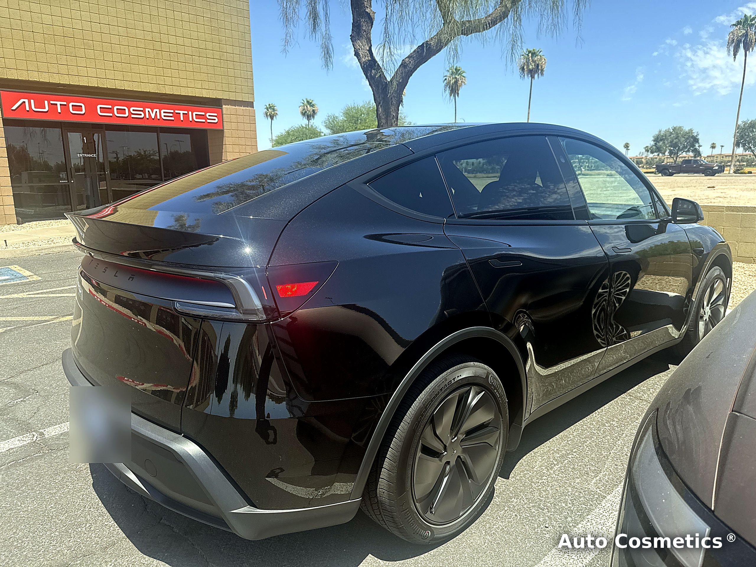 Tesla Model Y with paint protection film outside the Auto Cosmetics shop in Chandler, Arizona